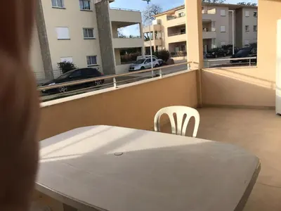 a white table and chairs on the balcony of a apartment at Appartement à Ghisonaccia-Prunelli in Prunelli-di-Fiumorbo