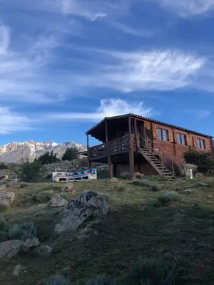 a house on top of a hill in a field at Les Chalets De Lozzi in Calacuccia