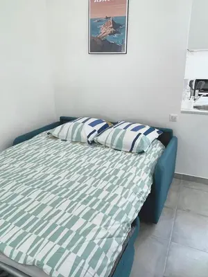 a bed with two pillows on it in a room at Studio 2 Personnes Plein Centre Rue Piétonne in Ajaccio