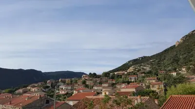 a town on a hill with houses and mountains at Appartement Corse Extrême-Sud in Monacia-dʼAullène
