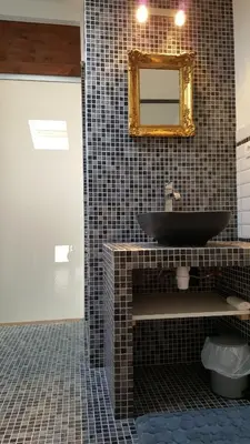 a bathroom with a black sink and a mirror at Appartement Corse Extrême-Sud in Monacia-dʼAullène