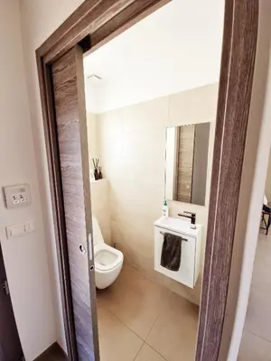 a bathroom with a toilet and a sink at Villa ALVALMAX in Porto-Vecchio