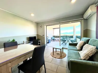 a living room with a couch and a table at Appartement ALERIA 2/4 personnes in Aléria