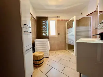 a small bathroom with a sink and a mirror at Appartement ALERIA 2/4 personnes in Aléria