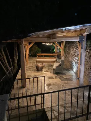 a wooden pavilion with a bench and a table at L'ALMA VIVA (Anciennement La Diligence) in Verdese