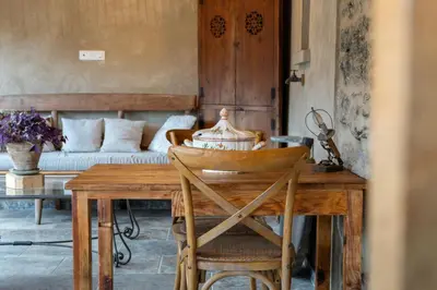 a dining room with a table and a couch at L'ALMA VIVA (Anciennement La Diligence) in Verdese