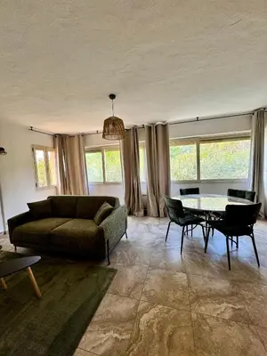 a living room with a couch and a table at Appartement à 2 pas de la plage in Olmeto