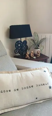 a bed with a pillow that reads lose be done anymore at Villa les pieds dans l'eau in Borgo