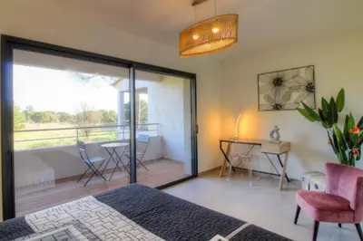 a bedroom with a bed and a sliding glass door at Villa moderne Cala Rossa Bay Les Oceanides in Lecci