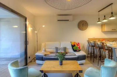 a living room with a couch and a table at Villa moderne Cala Rossa Bay Les Oceanides in Lecci
