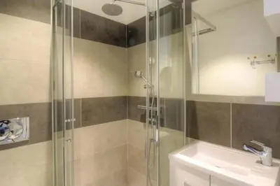 a bathroom with a glass shower and a sink at Villa moderne Cala Rossa Bay Les Oceanides in Lecci
