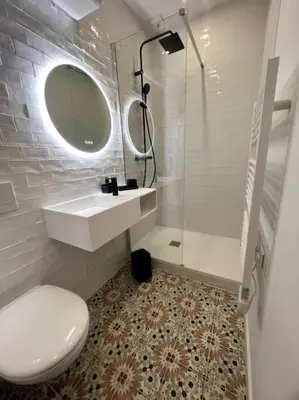 a bathroom with a toilet and a sink and a mirror at Joli appartement T1/Bis - Centre ville d’Ajaccio in Ajaccio