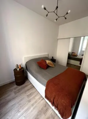 a bedroom with a bed with a brown blanket at Joli appartement T1/Bis - Centre ville d’Ajaccio in Ajaccio