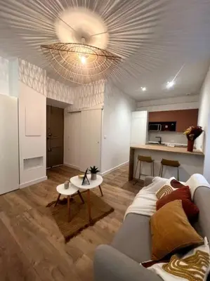 a living room with a couch and a table at Joli appartement T1/Bis - Centre ville d’Ajaccio in Ajaccio