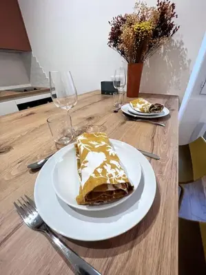 a piece of cake on a plate on a table at Joli appartement T1/Bis - Centre ville d’Ajaccio in Ajaccio