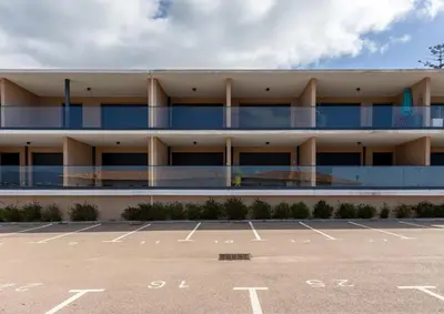 an empty parking lot in front of a building at Les Terrasses de l'Isolella - Vue mer et montagne in Pietrosella