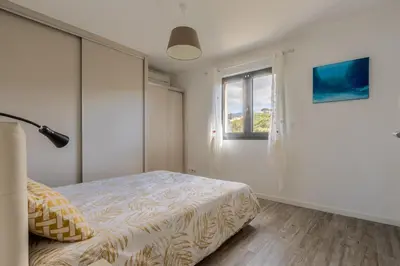 a bedroom with a bed and a window at Les Terrasses de l'Isolella - Vue mer et montagne in Pietrosella