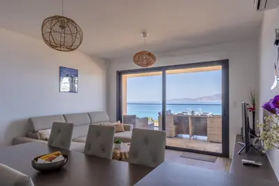 a living room with a view of the ocean at Les Terrasses de l'Isolella - Vue mer et montagne in Pietrosella