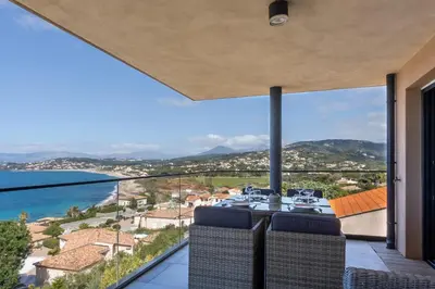 a view of the ocean from the balcony of a house at Les Terrasses de l'Isolella - Vue mer et montagne in Pietrosella