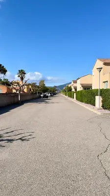 an empty street with cars parked on the side of the road at Maison en bord de mer, Plage de la Marana en Corse in Borgo