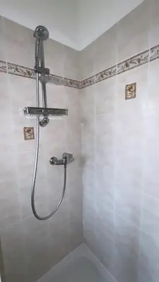 a shower with a shower head in a bathroom at Maison en bord de mer, Plage de la Marana en Corse in Borgo