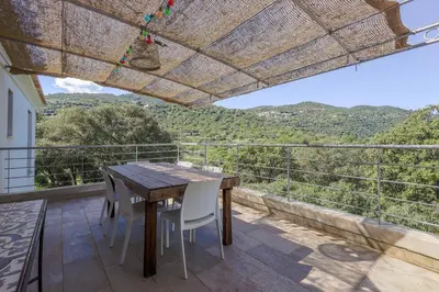 a living room with a couch and chairs and a window at San Quilico - Maison climatisée piscine vue mer in Aregno