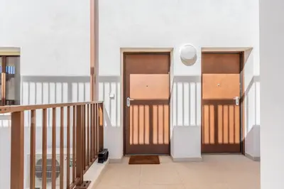 two doors in a room with a staircase at Magadhja Fiurita - Appt climatisé - Vue mer in Pietrosella