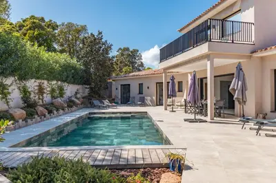 a swimming pool in the backyard of a house at Casa Campa di Pinarello in Sainte-Lucie de Porto-Vecchio