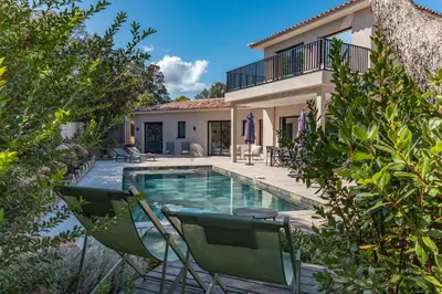 a villa with a swimming pool and a house at Casa Campa di Pinarello in Sainte-Lucie de Porto-Vecchio