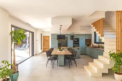 an open kitchen and dining room with a table and chairs at Casa Campa di Pinarello in Sainte-Lucie de Porto-Vecchio