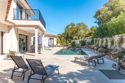 a patio with chairs and a swimming pool at Casa Campa di Pinarello in Sainte-Lucie de Porto-Vecchio