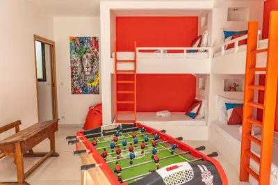 a room with a pool table and bunk beds at Casa Campa di Pinarello in Sainte-Lucie de Porto-Vecchio