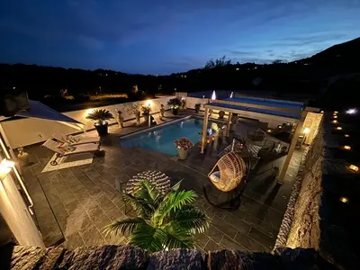 an overhead view of a swimming pool at night at Studio, piscine, 10 min des plages, Ajaccio, corse du sud, in Appietto