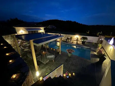 an overhead view of a house with a swimming pool at night at Studio, piscine, 10 min des plages, Ajaccio, corse du sud, in Appietto