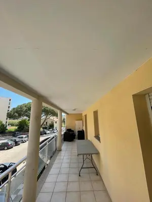 a balcony of a building with a desk on it at Immeuble le Mozart in Ajaccio