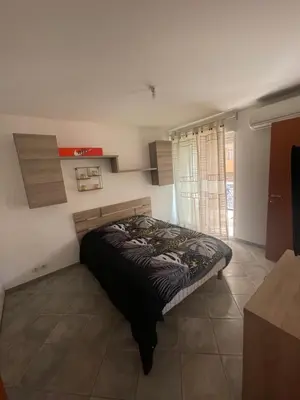 a bedroom with a bed in a room at Immeuble le Mozart in Ajaccio