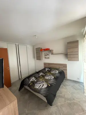 a bedroom with a bed in a room at Immeuble le Mozart in Ajaccio