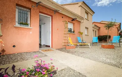 a house with chairs and flowers in front of it at Awesome Home In Prunete With Wifi in Prunete