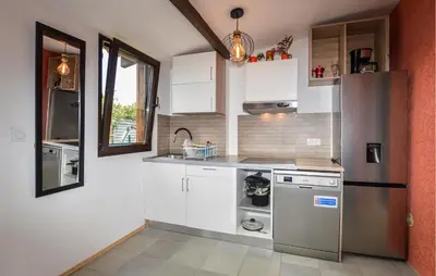 a kitchen with white cabinets and a stainless steel refrigerator at Awesome Home In Prunete With Wifi in Prunete