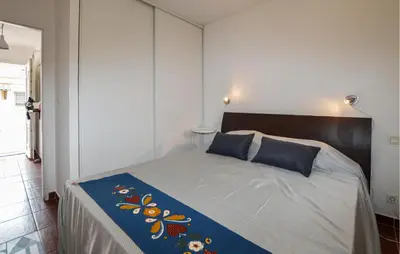 a bedroom with a large bed with blue pillows at Awesome Home In Prunete With Wifi in Prunete