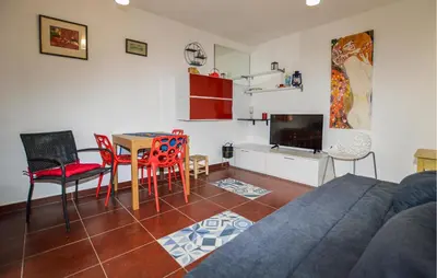 a living room with a couch and a table and chairs at Awesome Home In Prunete With Wifi in Prunete