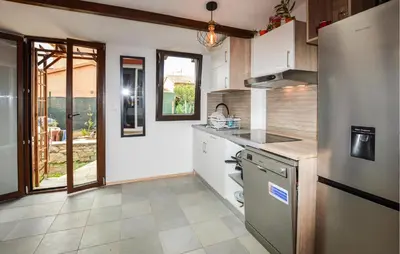 a kitchen with a refrigerator and a stove at Awesome Home In Prunete With Wifi in Prunete