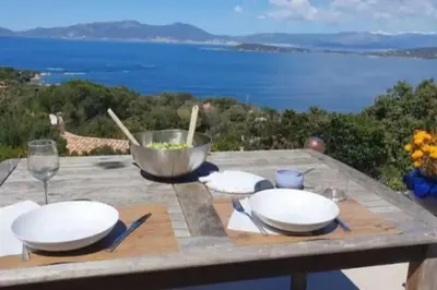 a picnic table with a view of the ocean at loft de standing 150 m2 vue mer,de 2 à 6 pers à Mare e Sole Plage d'argent Verghia in Coti-Chiavari