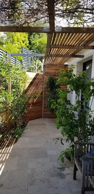 a wooden pergola with a bench in a garden at loft de standing 150 m2 vue mer,de 2 à 6 pers à Mare e Sole Plage d'argent Verghia in Coti-Chiavari