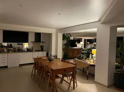 a kitchen with a wooden table and a dining room at loft de standing 150 m2 vue mer,de 2 à 6 pers à Mare e Sole Plage d'argent Verghia in Coti-Chiavari