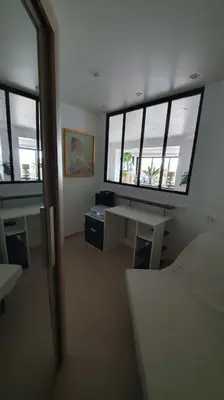 a room with a desk and two windows in a building at loft de standing 150 m2 vue mer,de 2 à 6 pers à Mare e Sole Plage d'argent Verghia in Coti-Chiavari