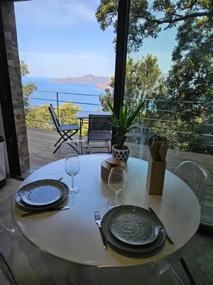a white table with two plates and wine glasses at U Paradisu in Piana