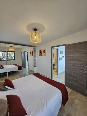a bedroom with a large bed and a chandelier at U Paradisu in Piana