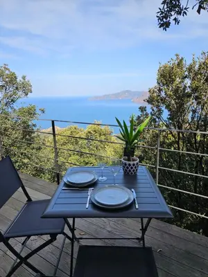 a blue table with plates and a plant on a deck at U Paradisu in Piana