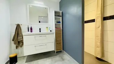 a bathroom with a sink and a mirror at CASA CUCCHI in Porto-Vecchio